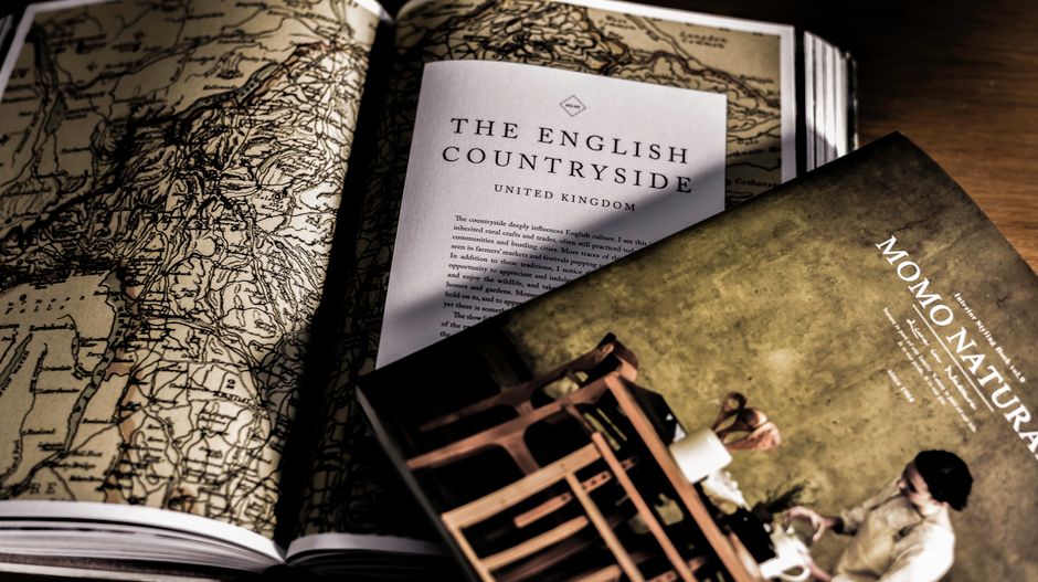 Close-up of vintage books featuring English countryside and design with detailed maps and elegant covers.